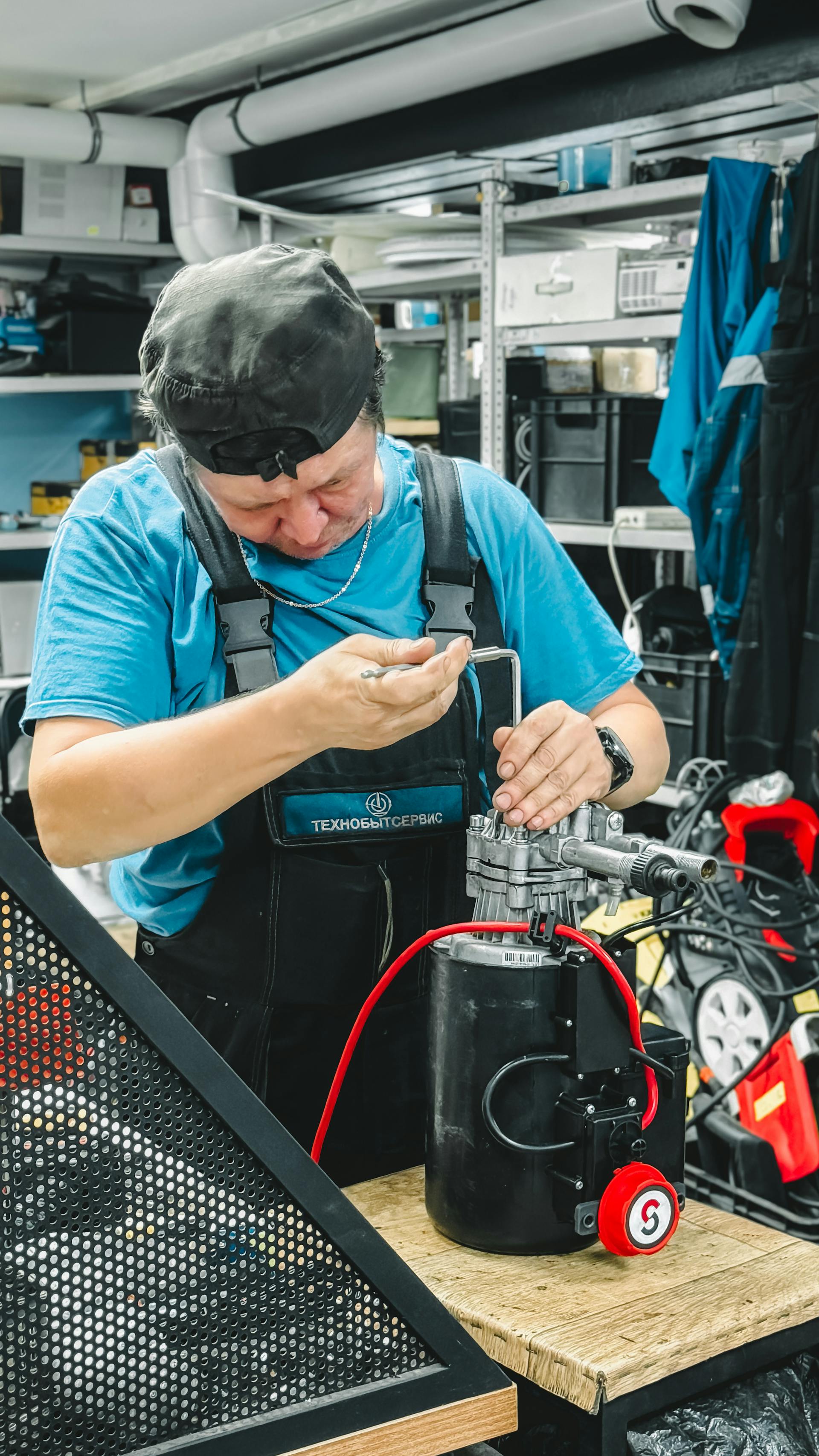 Technician working on hydraulic equipment